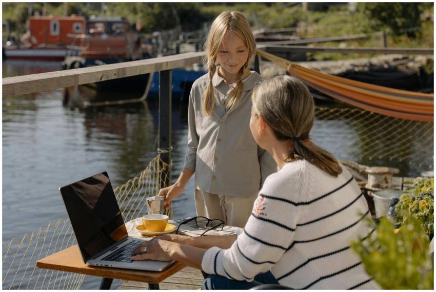 Mother and daughter working with a laptop on a doc