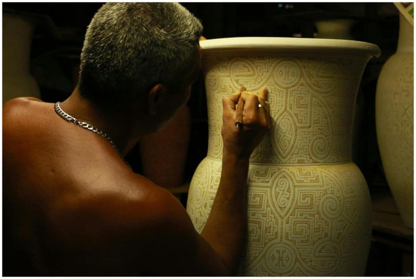 Close-up of a man skillfully engraving detailed pa