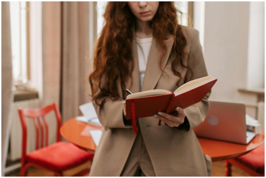 Young businesswoman in office holding and reading