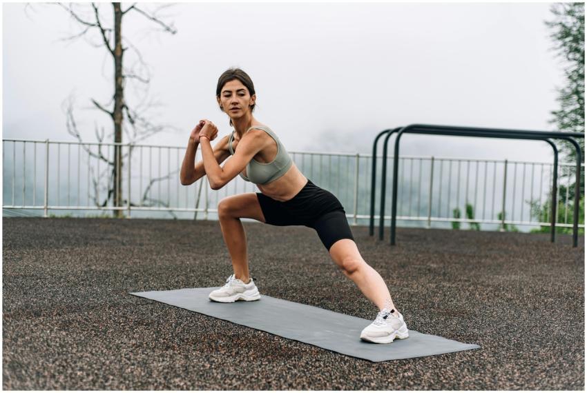 Woman exercising outdoors on yoga mat with a sceni