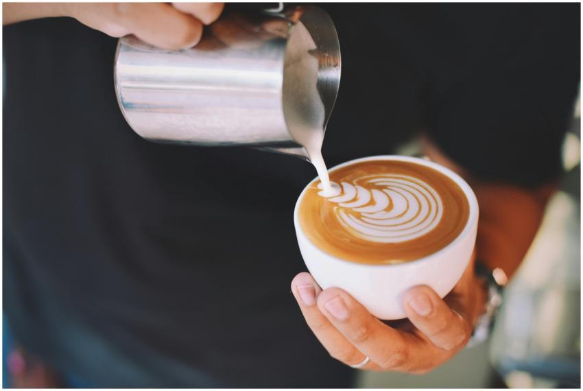Captivating image of a barista pouring milk art in