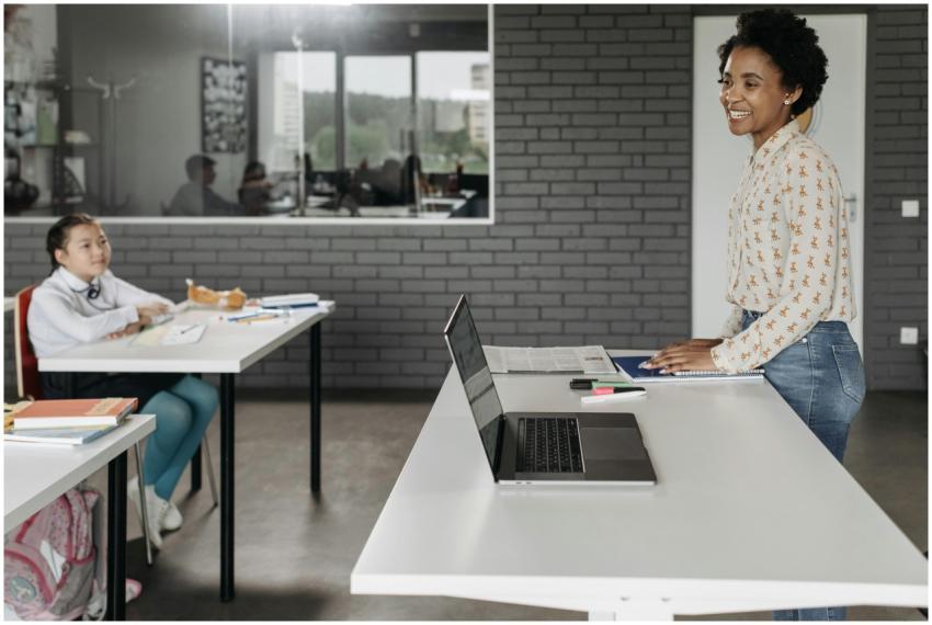 Teacher engaging with student in a modern classroo