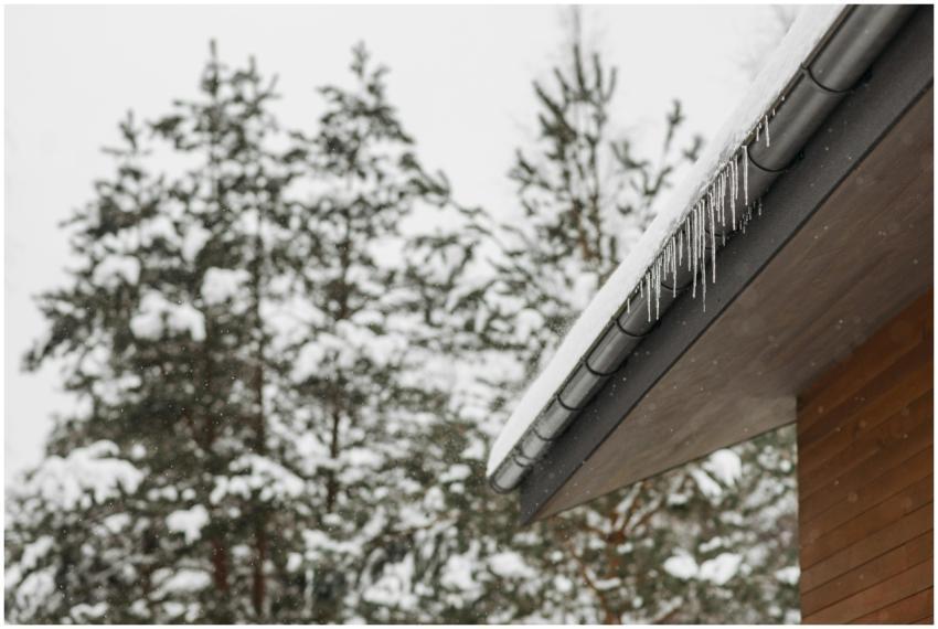 Stunning winter scene of icicles hanging from a sn