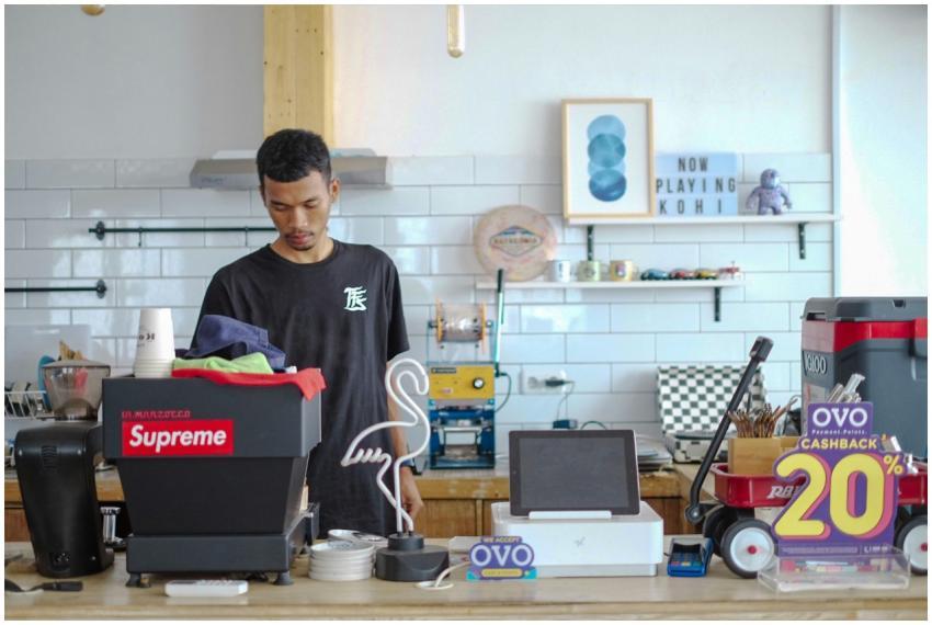 Young barista in Indonesia preparing coffee in a s