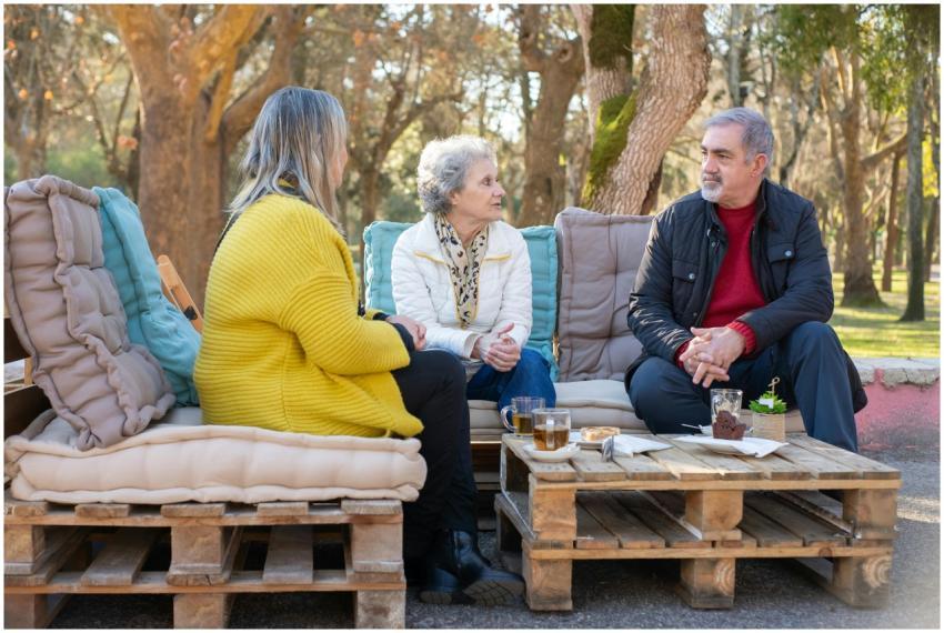 Three senior adults enjoying tea and conversation