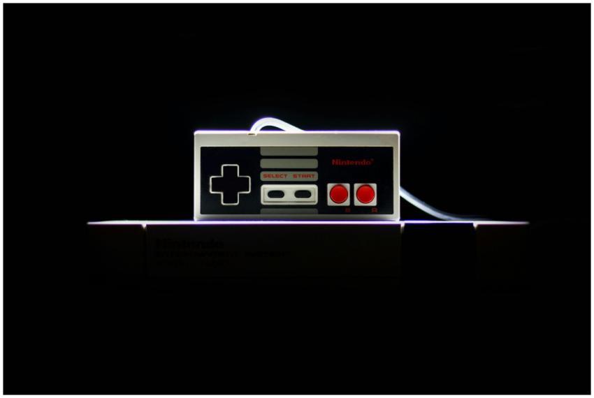A close-up of a classic NES controller with dramat