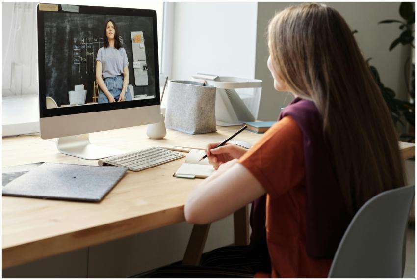 Teen girl attending an online class at home, takes