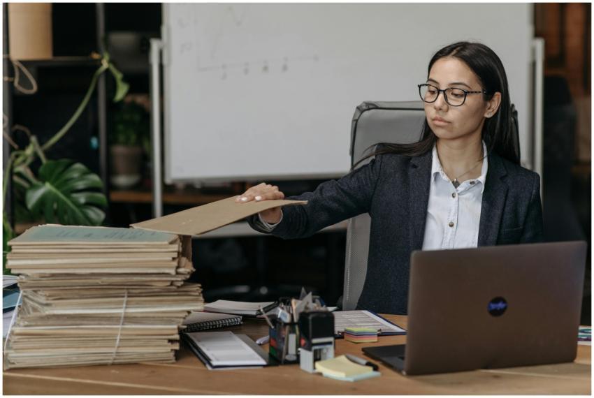 A businesswoman in a modern office organizing a st