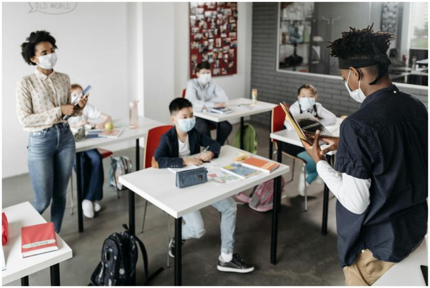 A diverse group of students and a teacher wearing