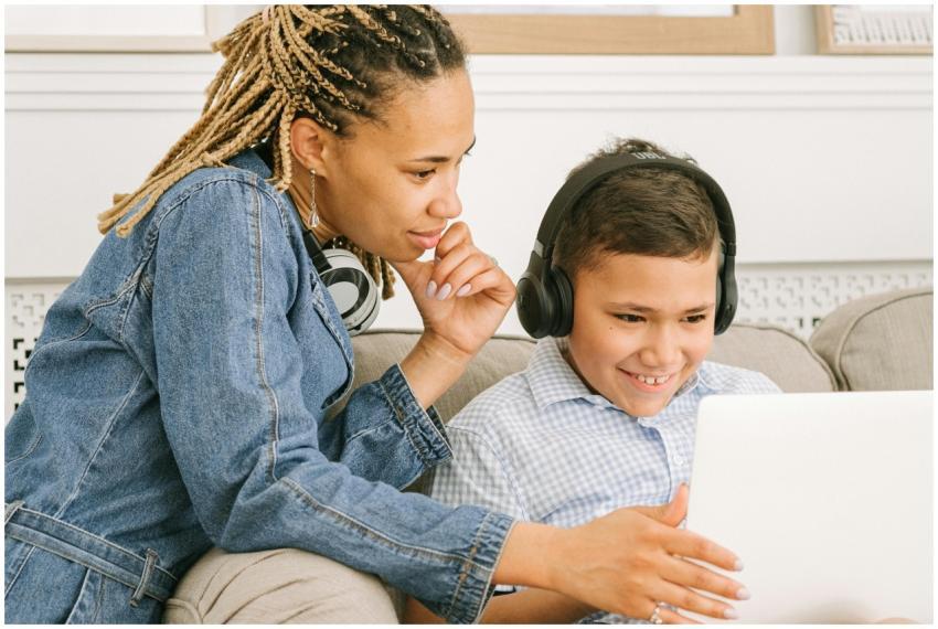 A mother and her son share a joyful online learnin