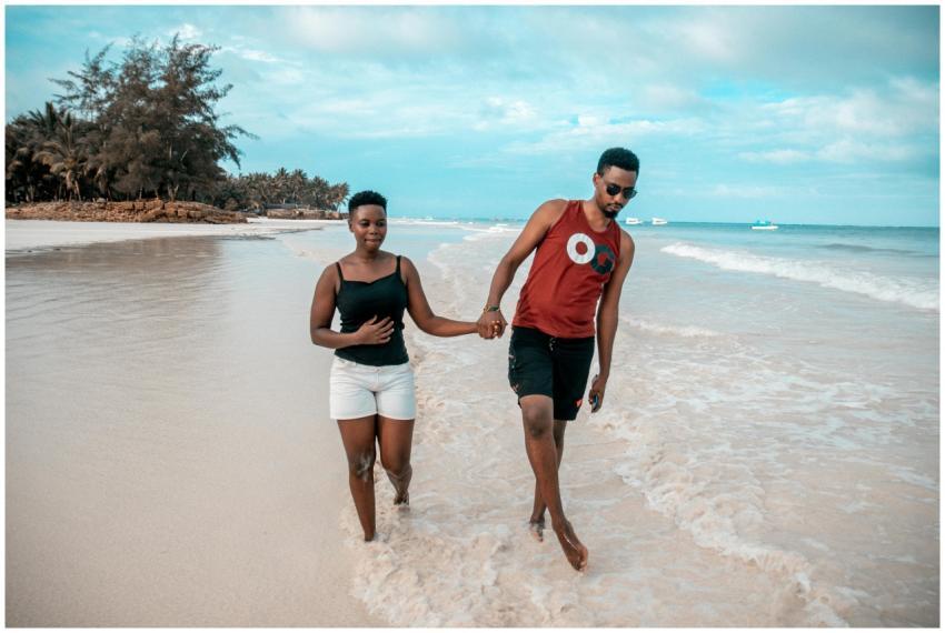 A couple enjoying a romantic walk by the beach in