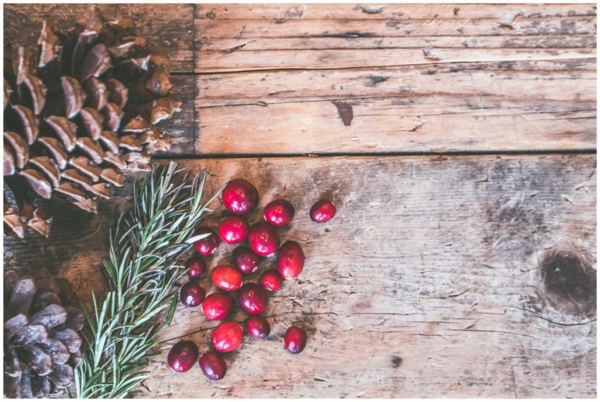 Top view of rustic holiday decor featuring pinecon