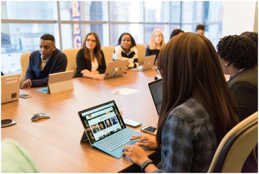 Team collaboration in a tech-driven office, focuse