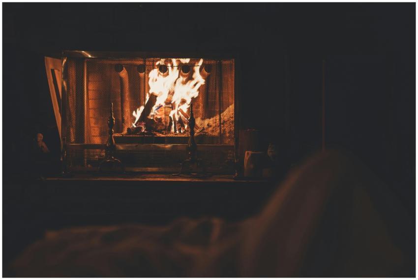 A cozy indoor fireplace with vivid flames, offerin