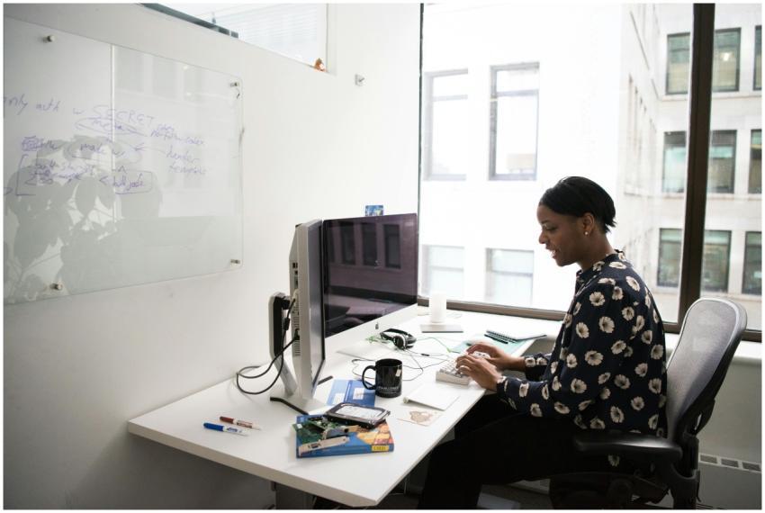 Woman sitting at a desk in a modern office, workin