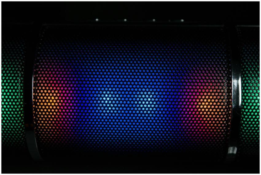 Vibrant LED lights illuminate a speaker grille wit