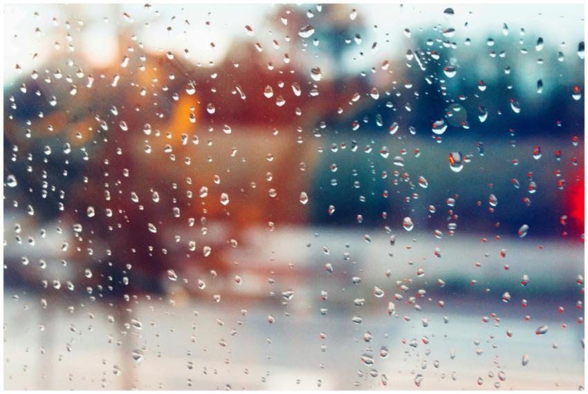 Rain droplets on window creating a blurry, colorfu