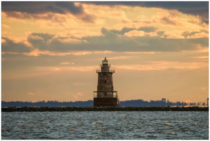 Beautiful sunset view of a rustic lighthouse surro