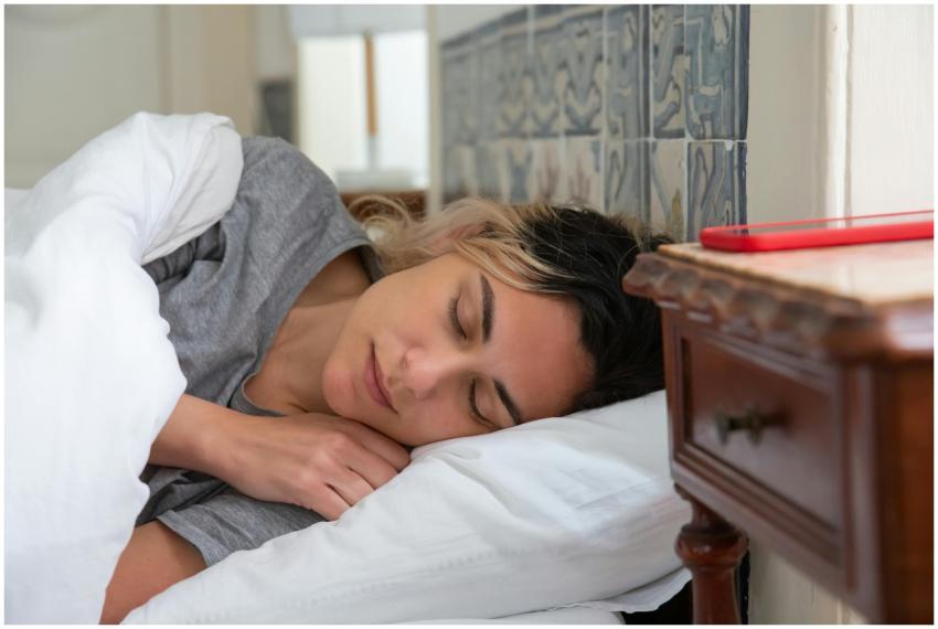 A woman peacefully sleeping in a cozy bedroom with
