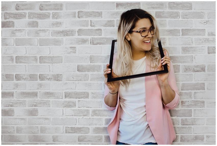 Cheerful woman with blonde hair posing creatively