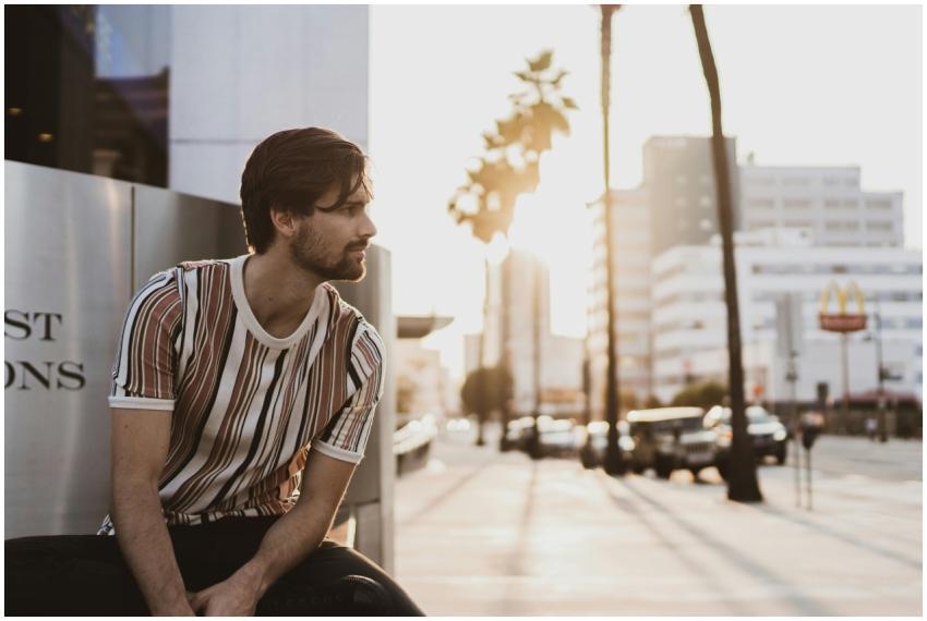 Stylish man sitting in urban Los Angeles at sunset