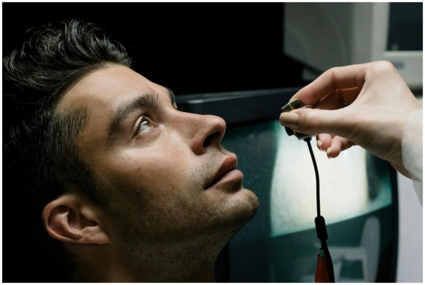 Close-up of a man in a lab setting looking up duri
