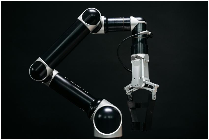 Close-up of a mechanical robotic arm with a dark b