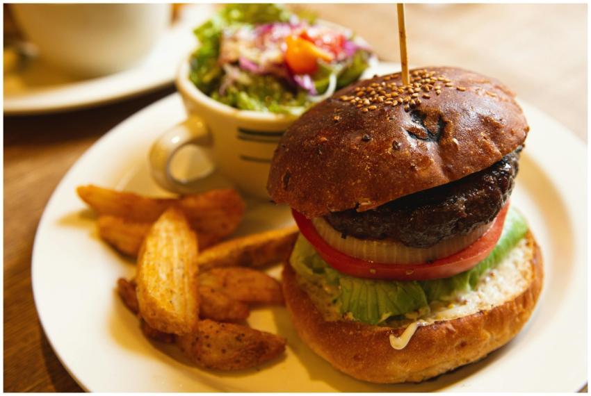 Delicious burger with fries and salad served on a