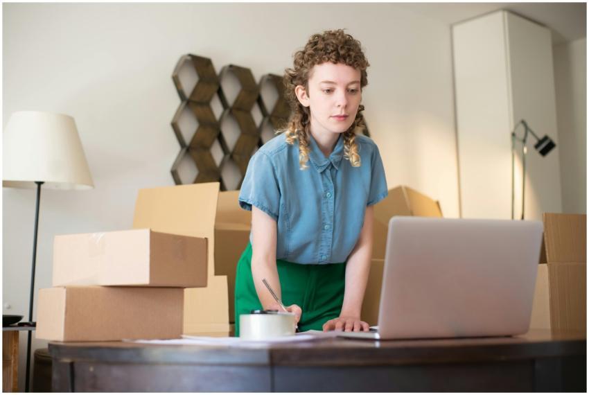 A young woman working on her laptop surrounded by