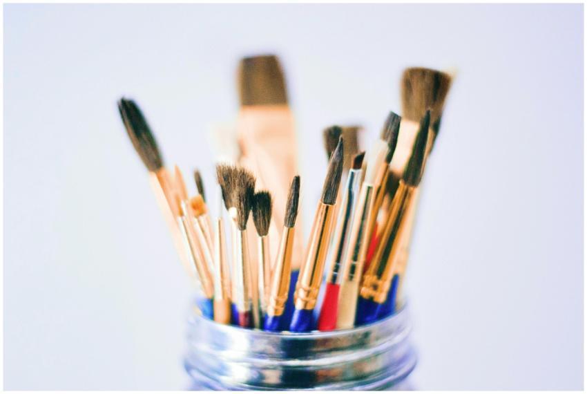 Collection of various paintbrushes in a jar ready