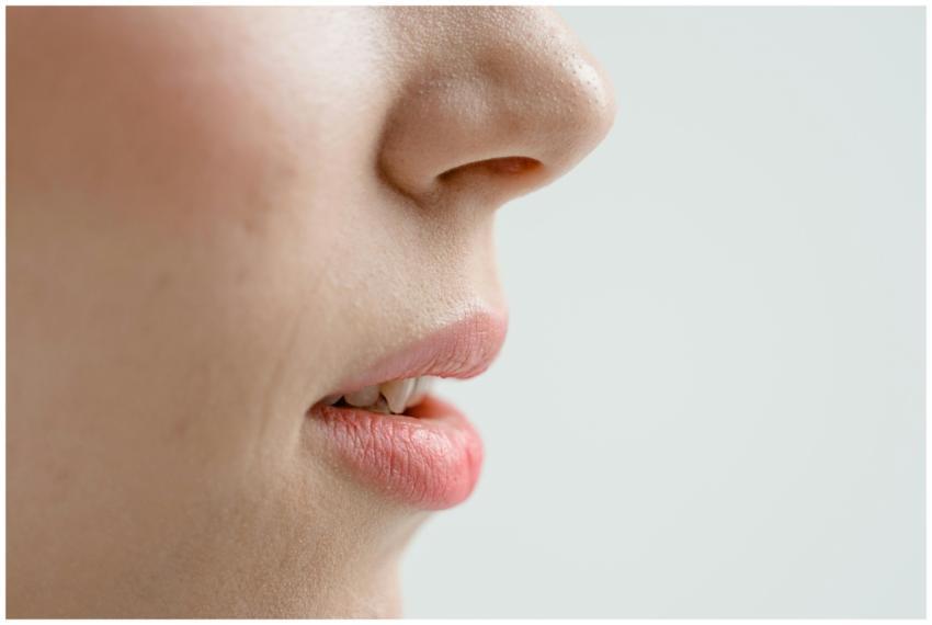 Detailed side view of a woman's nose and lips with