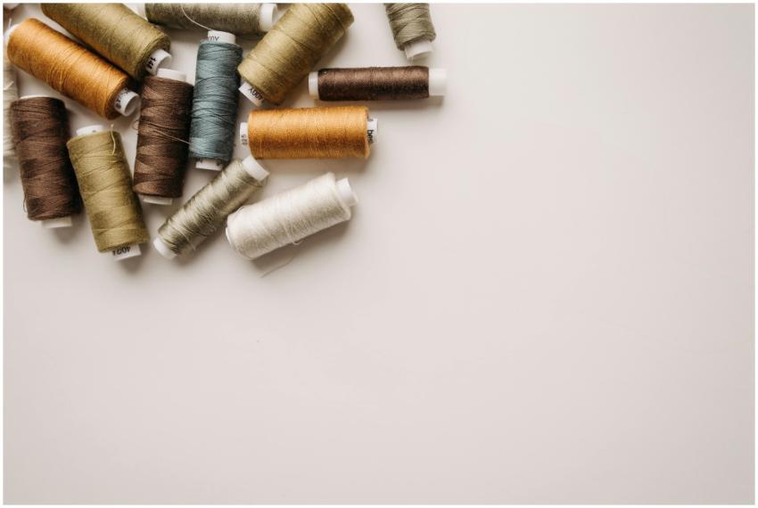 Top view of various colored spools of thread on a