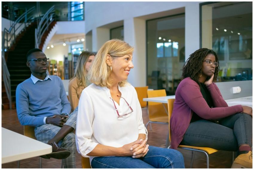Multiethnic group of students with teacher sitting