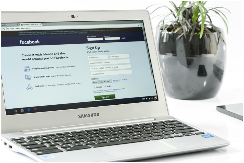 Open Samsung laptop showing Facebook sign-up page