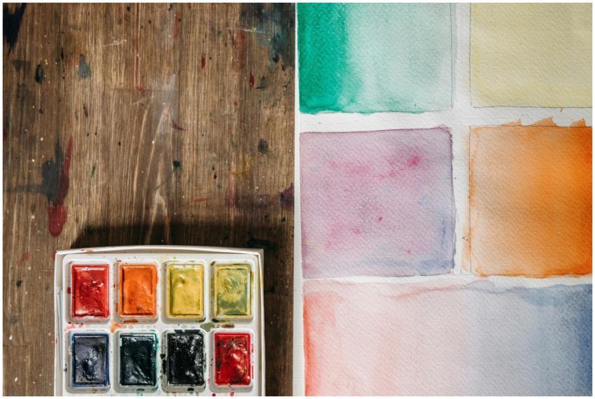 A watercolor palette with various color swatches o