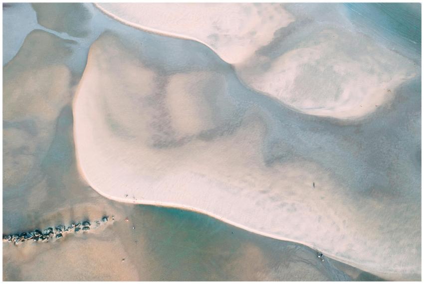 Aerial view of sandy shores with ocean patterns, c