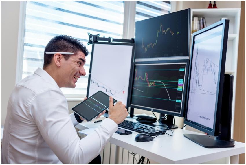 A man engaged in financial data analysis on multip