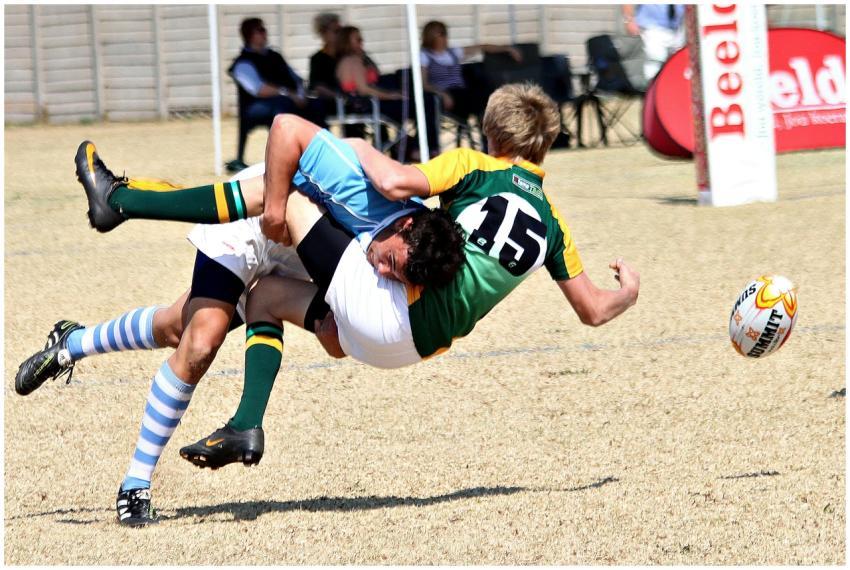 Two rugby players collide mid-air in an action-pac