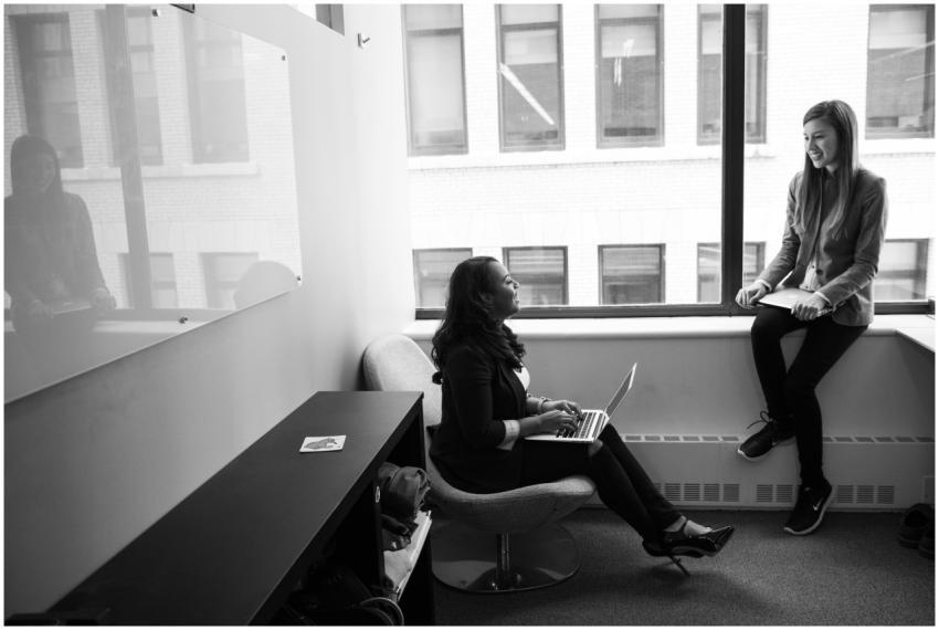 Two women collaborating in an office setting, embr