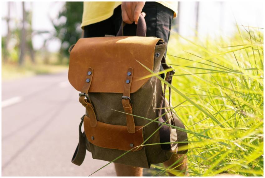 Outdoor scene featuring a person holding a leather