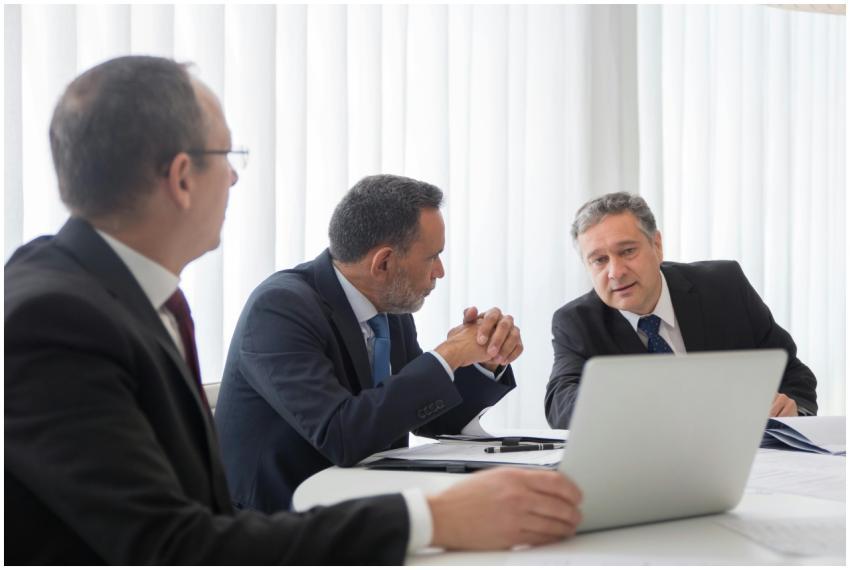 Three businessmen collaborating during a meeting a