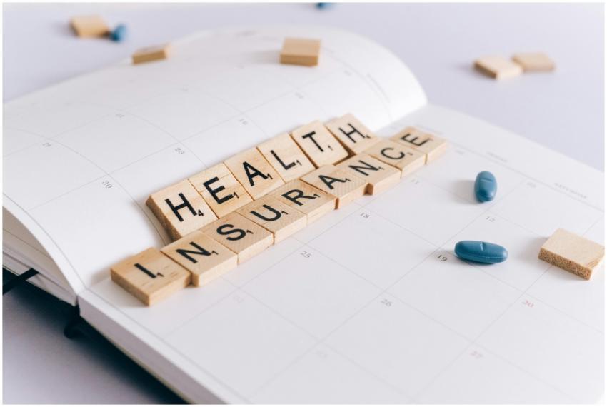 Scrabble tiles spelling 'Health Insurance' on a ca