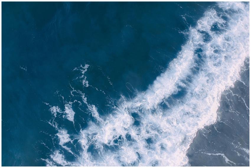 Breathtaking aerial shot of ocean waves crashing o