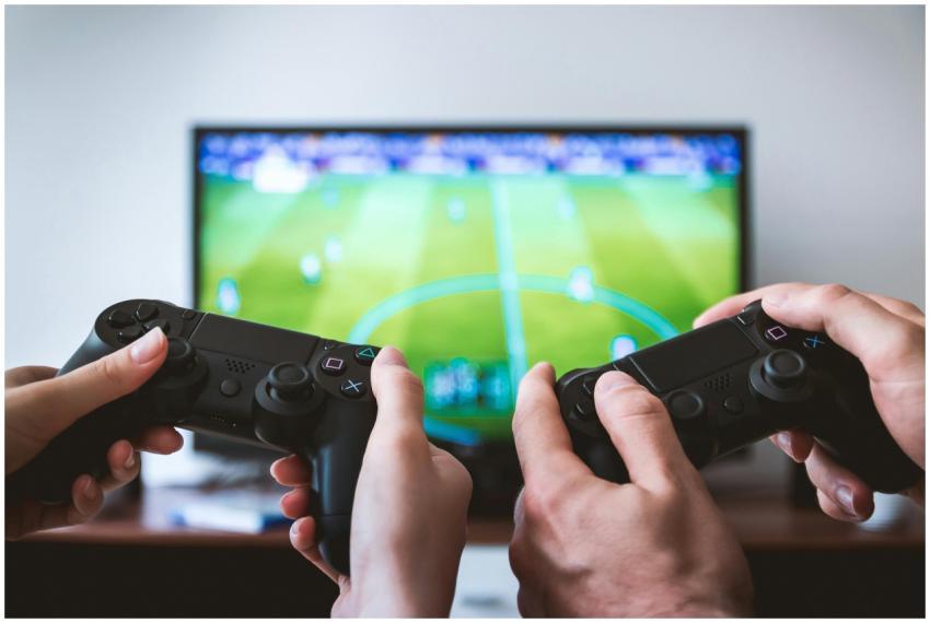 Close-up of hands holding gaming controllers in fr