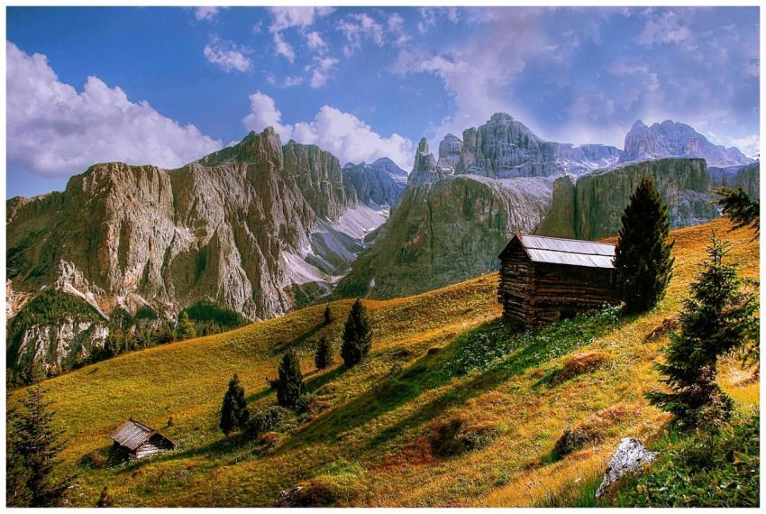 Idyllic alpine landscape with cabins and towering