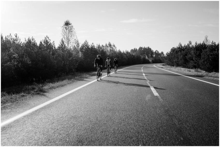 Cyclists riding on a quiet country road in a grays