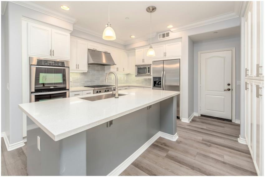 Modern kitchen interior featuring sleek white cabi