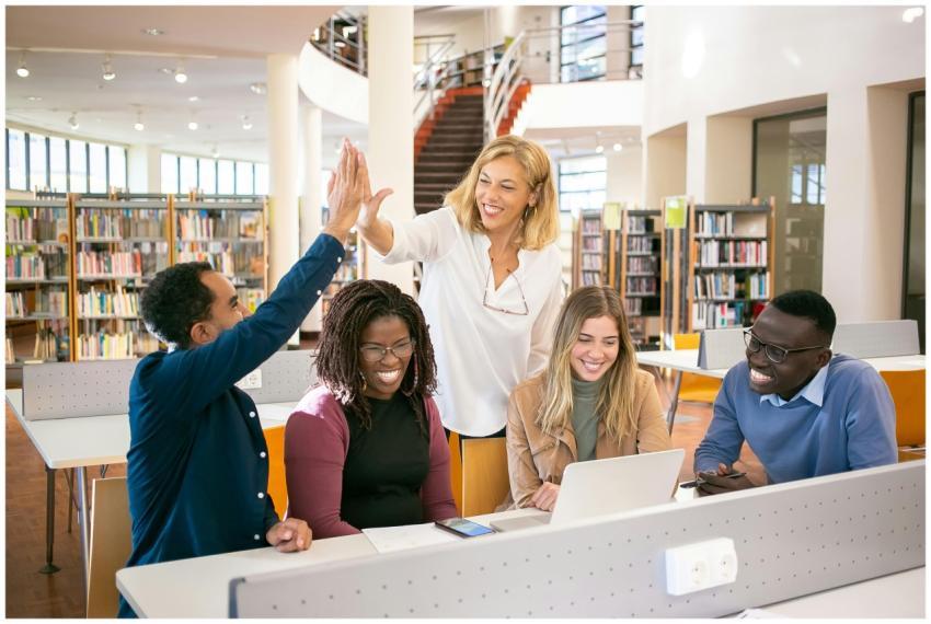 Cheerful diverse group of students collaborating i