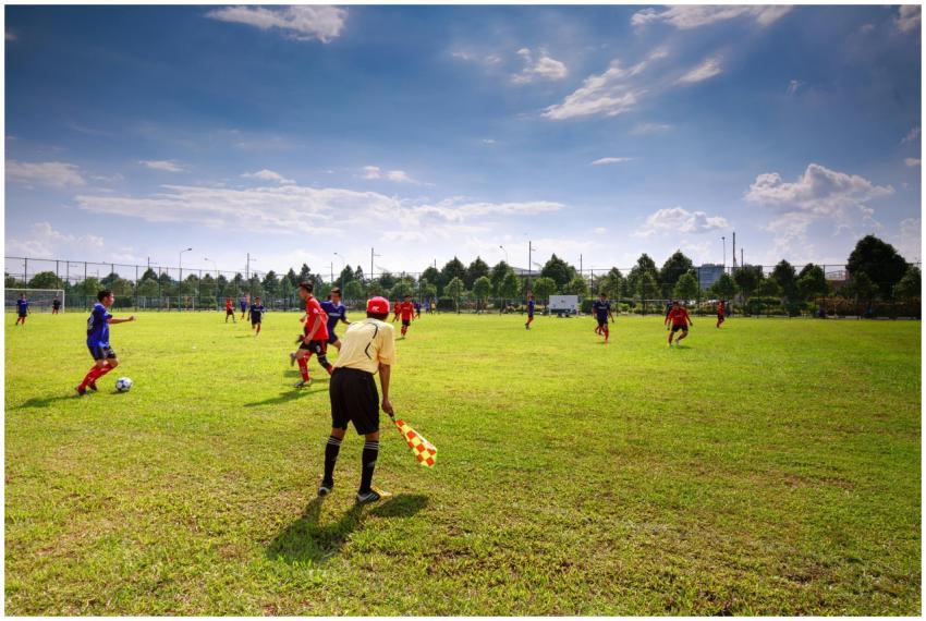 Youth soccer match in outdoor field with players,