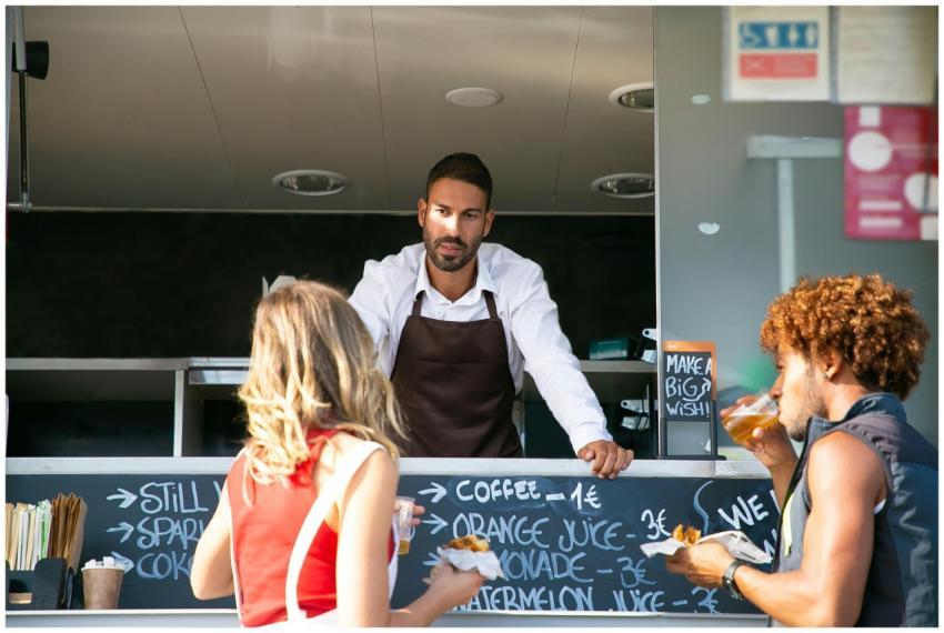 Street food vendor serves customers at a food truc